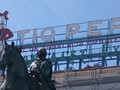 The Tio Pepe sign in the daytime as Phillip II watches over the shoppers and loiterers at Plaza del Sol.