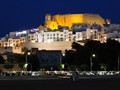 The beautiful white walls of Peniscola shining at night.