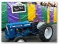 Guys driving tractors drag each and every float down the route.