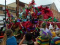 The floats of Mid-City are decorated with shiny, colorful foil.