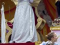 The queen of Thoth greets the crowds as her maids throw piles of dubloons into the street.