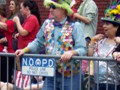 A big fan wearing a dubloon-encrusted vest.
