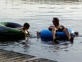 Andrew and Uncle Micah float around in the sandy, crayfish-covered shallows.