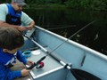 Effortlessly, Andrew catches a tiny bluegill.